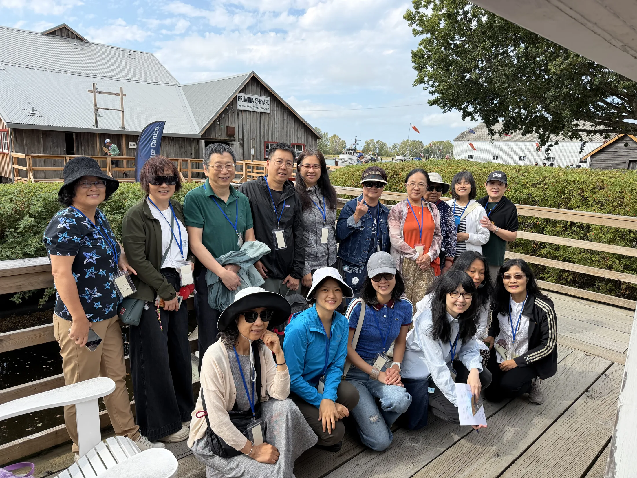 Neighbours smiling together at Britannia Shipyards during the Steveston community walk.