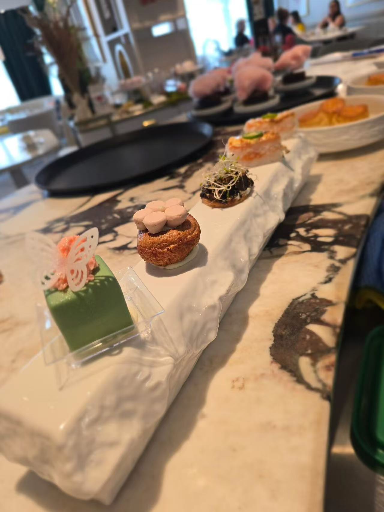 A row of delicate pastries made in a cafe.